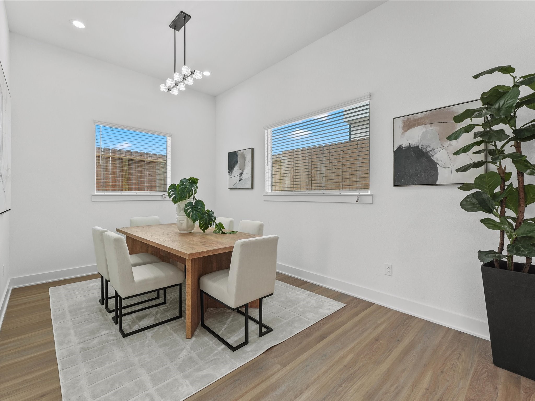 2592 West Tidwell Road Houston, TX 77091 - Photo 10 of 25 a dining room with chandelier and wooden floor