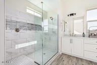 23175 West Skinner Road Wittmann, AZ 85361 - Photo 13 of 35 a bathroom with a glass shower door