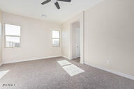 23175 West Skinner Road Wittmann, AZ 85361 - Photo 29 of 35 an empty room with windows and fan