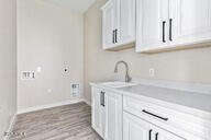 23175 West Skinner Road Wittmann, AZ 85361 - Photo 32 of 35 a kitchen with white cabinets and a sink