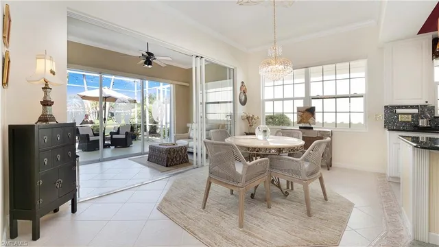 a dining room with furniture a chandelier and wooden floor