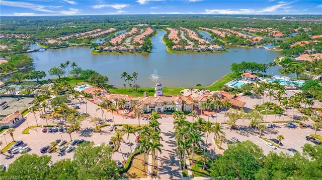 an aerial view of lake and residential houses with outdoor space