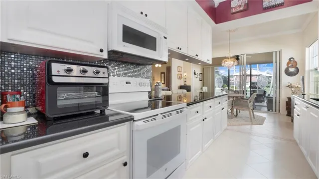 a large white kitchen with stainless steel appliances