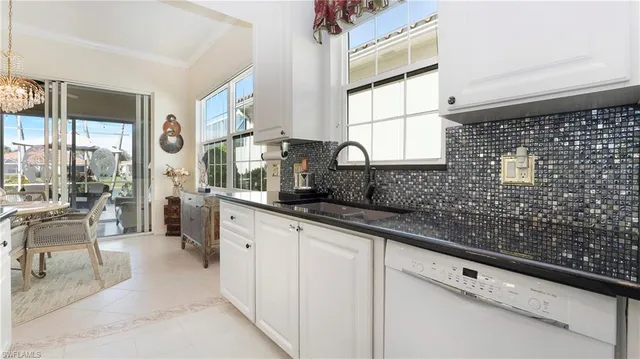a kitchen with granite countertop a sink and a large window