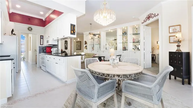 a dining room with furniture and chandelier