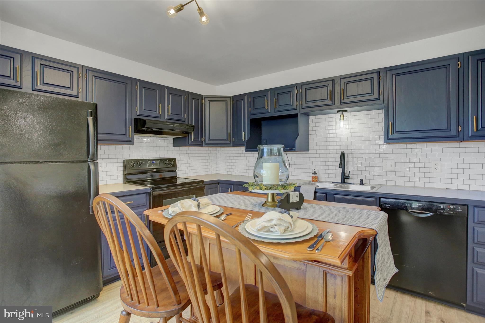 1553 Brechbill Road Chambersburg, PA 17202 - Photo 20 of 45 a kitchen with stainless steel appliances granite countertop a sink a stove a refrigerator cabinets and a dining table