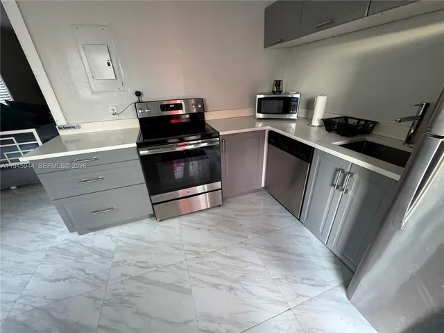 a kitchen with a stove and a microwave