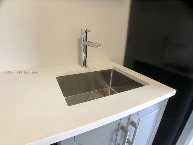 a close view of a sink and dishwasher in a kitchen