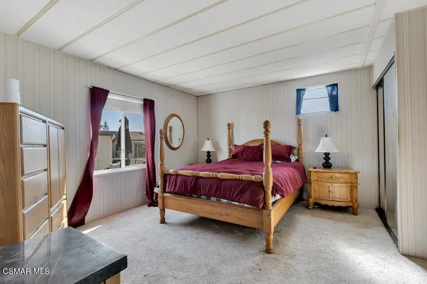 a bed room with a bed and a window
