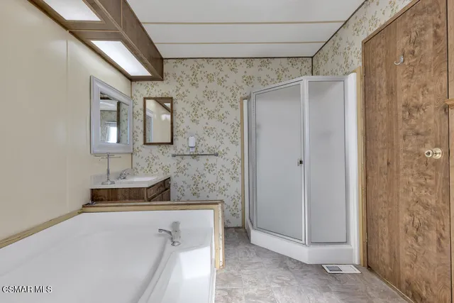 a bathroom with a shower and a sink