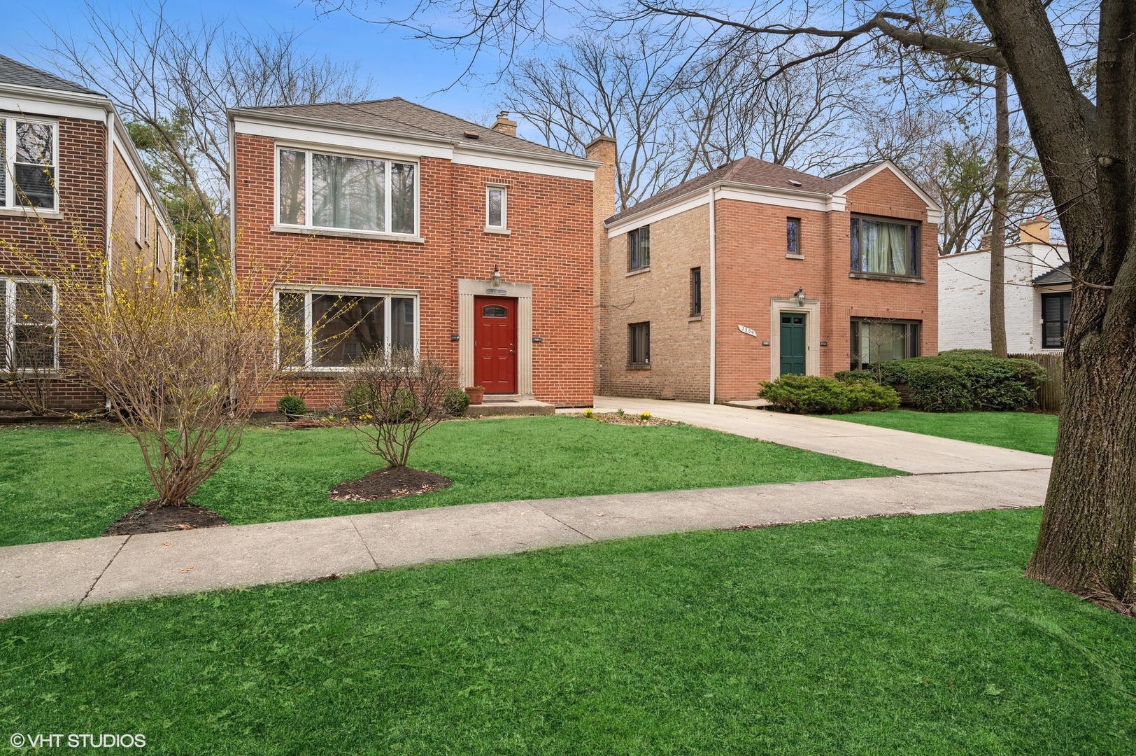 a front view of a house with a yard and trees