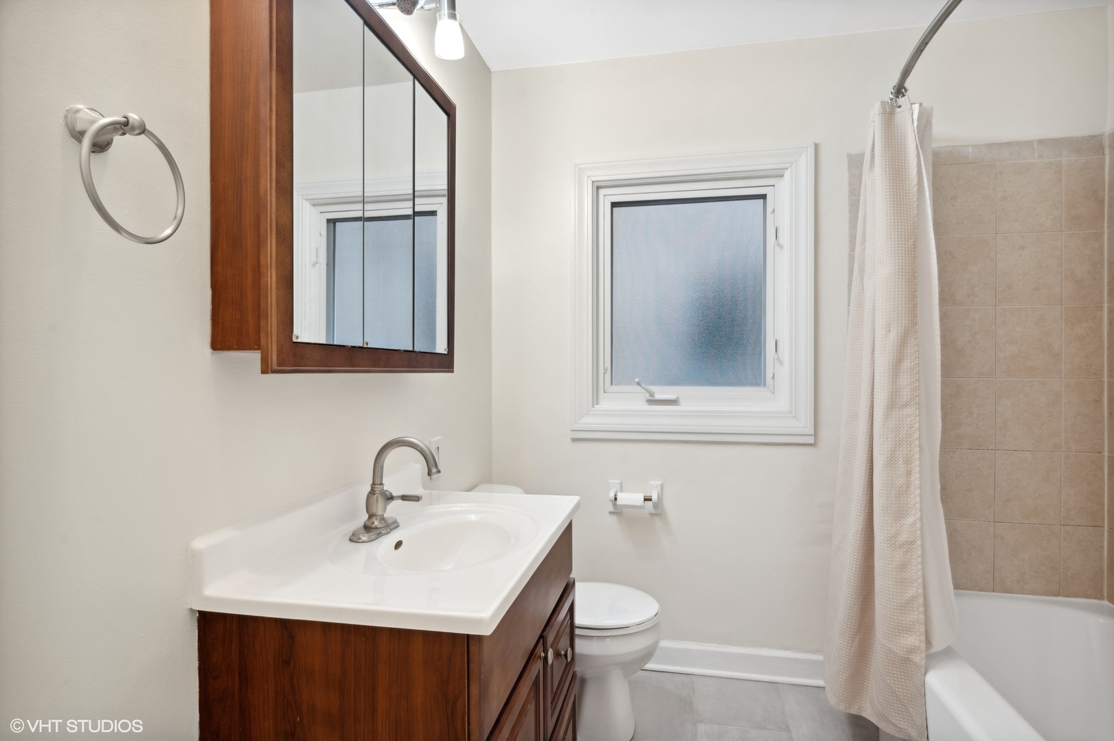 2311 Brown Avenue, Unit 1 Evanston, IL 60201 - Photo 11 of 13 a bathroom with a sink toilet and mirror