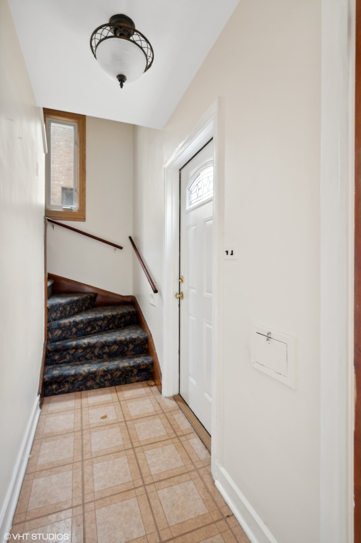 2311 Brown Avenue, Unit 1 Evanston, IL 60201 - Photo 5 of 13 a view of a hallway with wooden floor and staircase