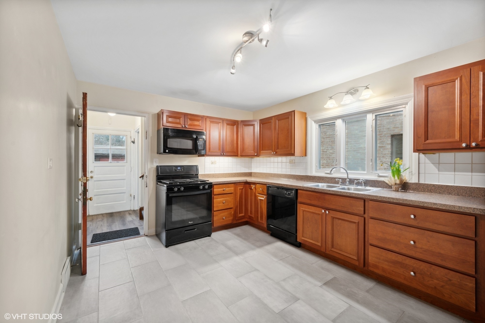 2311 Brown Avenue, Unit 1 Evanston, IL 60201 - Photo 6 of 13 a kitchen with granite countertop stainless steel appliances and wooden cabinets