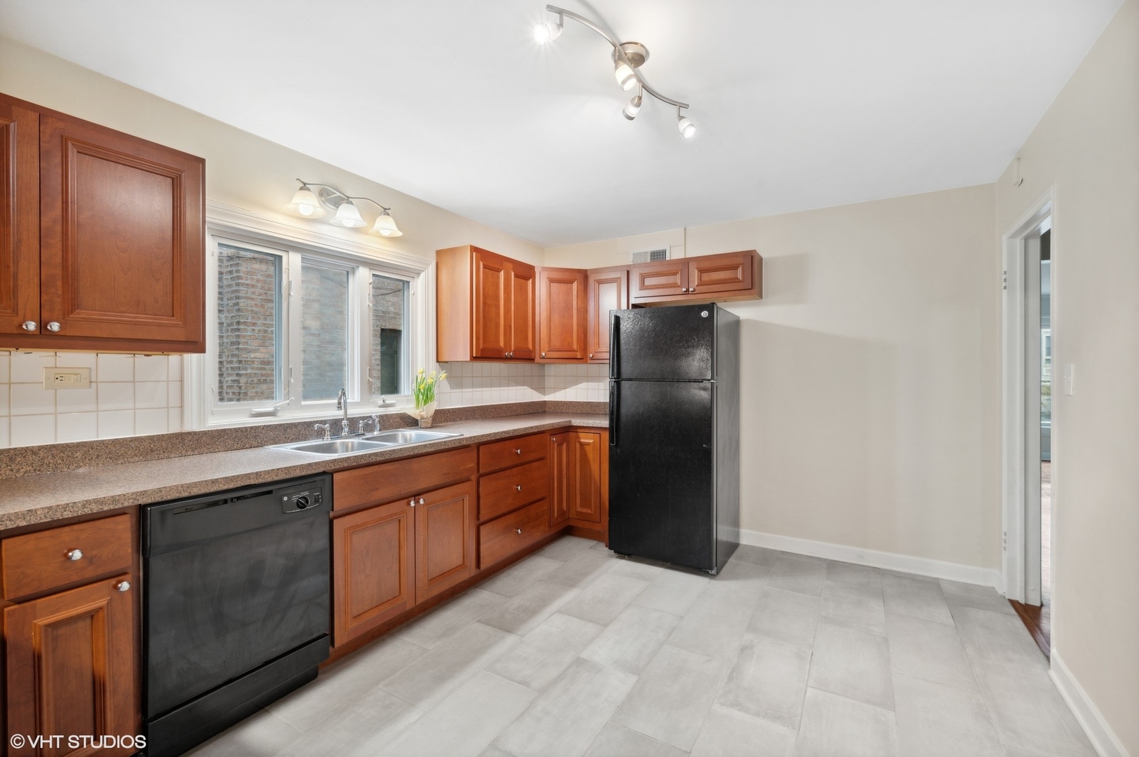 2311 Brown Avenue, Unit 1 Evanston, IL 60201 - Photo 7 of 13 a kitchen with stainless steel appliances granite countertop a refrigerator and a sink