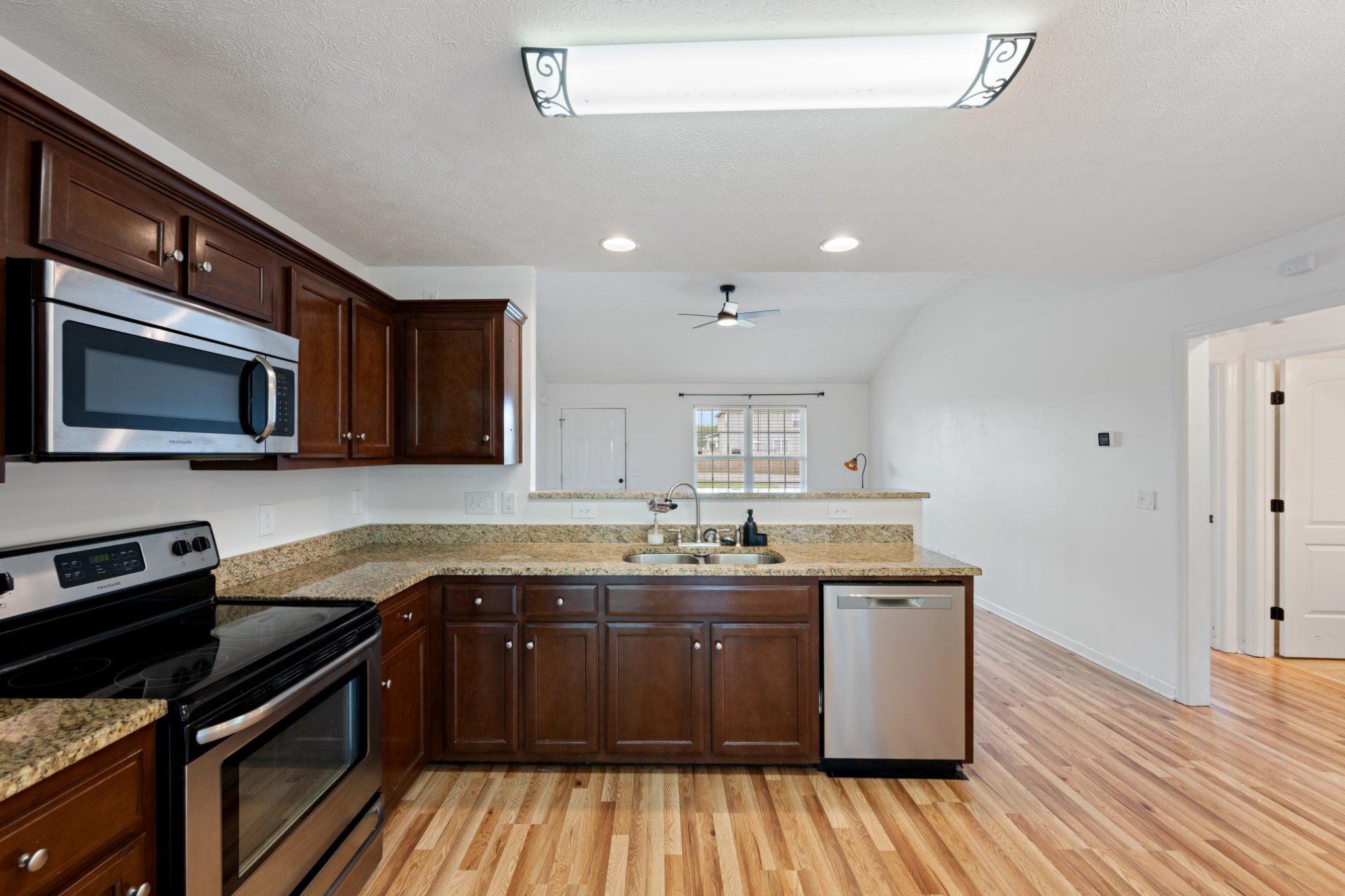 16 Andy Circle Lebanon, TN 37087 - Photo 6 of 25 a kitchen with stainless steel appliances granite countertop wooden cabinets a stove top oven a sink and dishwasher with wooden floor