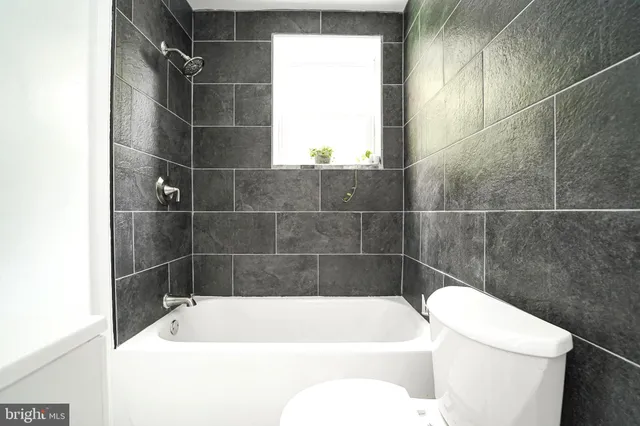 a bathroom with a bathtub and toilet