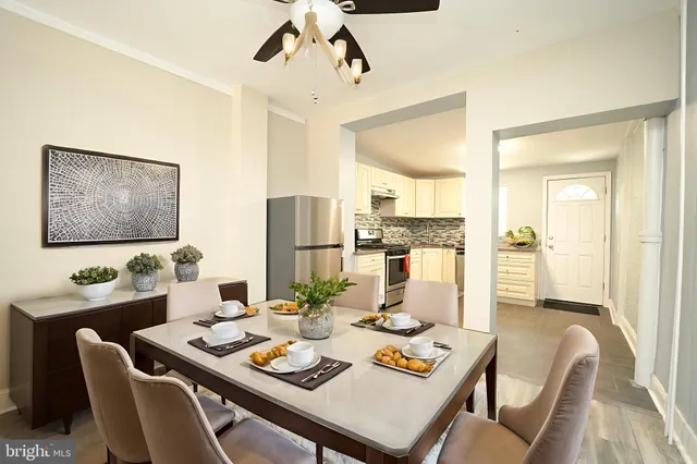 a dining room with furniture a rug and wooden floor