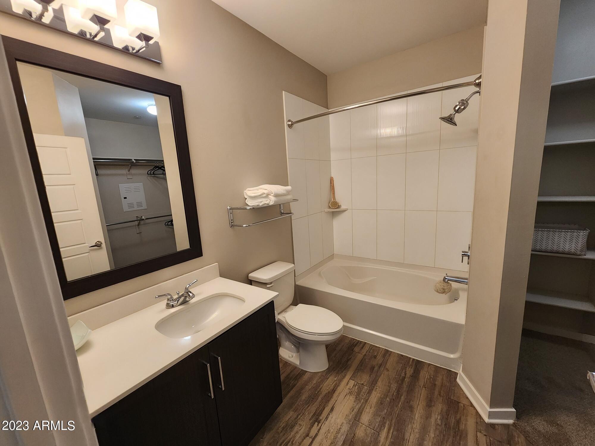 200 East Thomas Road, Unit A1 Phoenix, AZ 85012 - Photo 5 of 26 a bathroom with a sink a toilet a mirror and shower