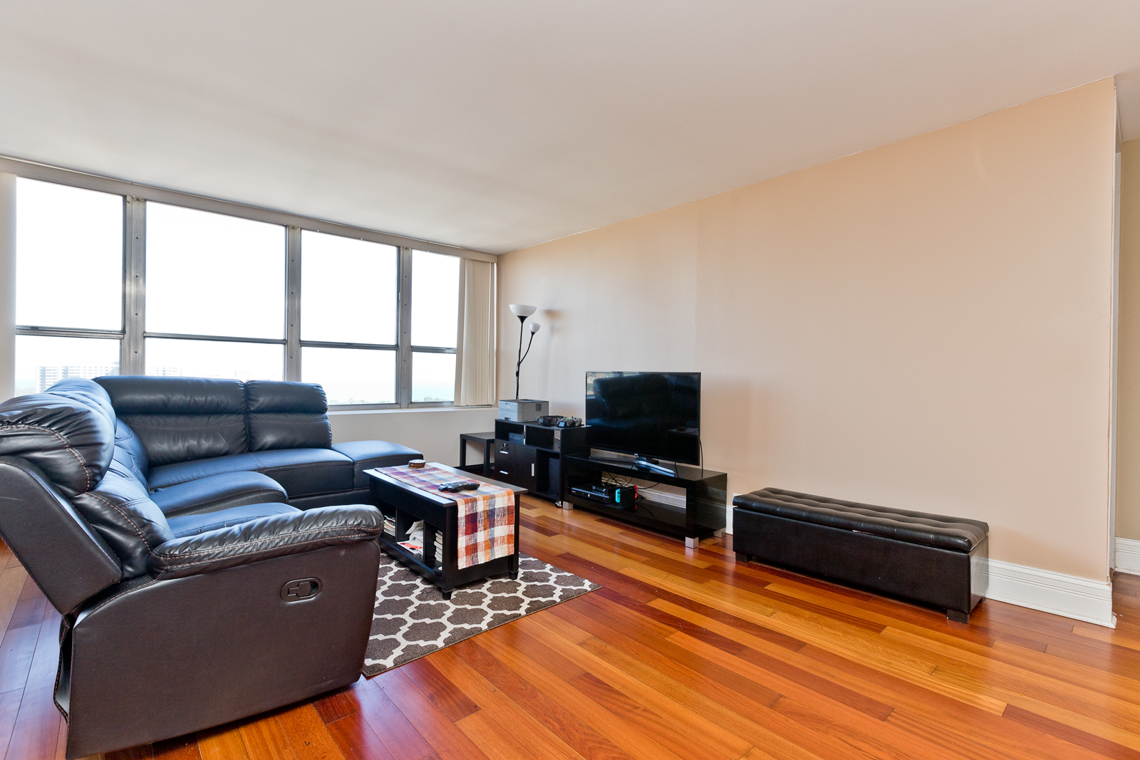 655 West Irving Park Road, Unit 2512 Chicago, IL 60613 - Photo 11 of 18 a living room with furniture and a flat screen tv