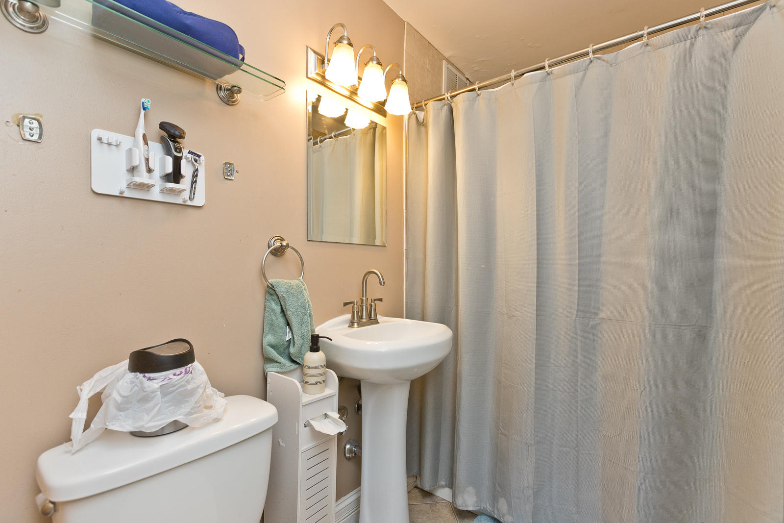 655 West Irving Park Road, Unit 2512 Chicago, IL 60613 - Photo 12 of 18 a bathroom with a sink a toilet and shower curtain