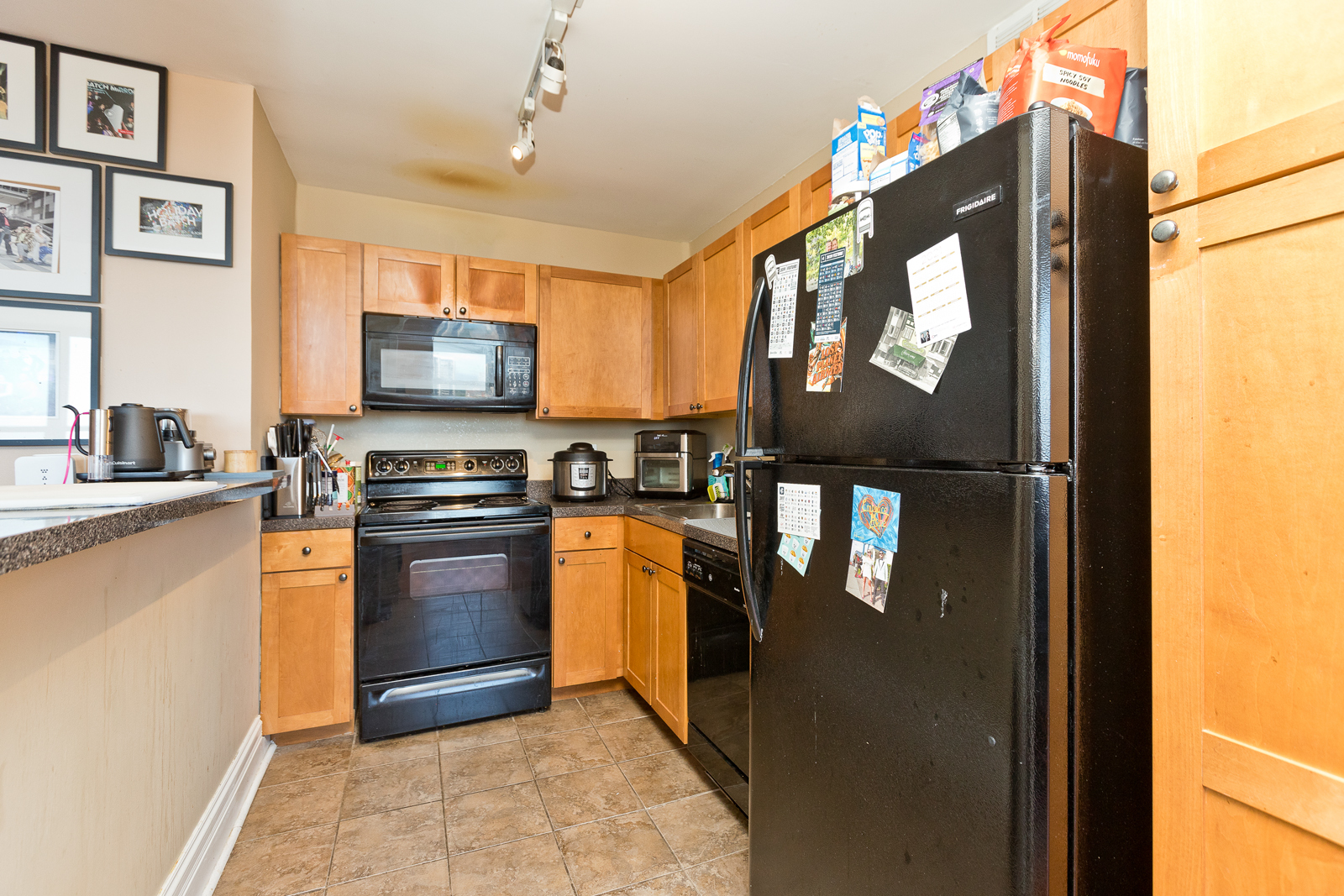 655 West Irving Park Road, Unit 2512 Chicago, IL 60613 - Photo 3 of 18 a kitchen with stainless steel appliances granite countertop a refrigerator a stove top oven a sink and dishwasher