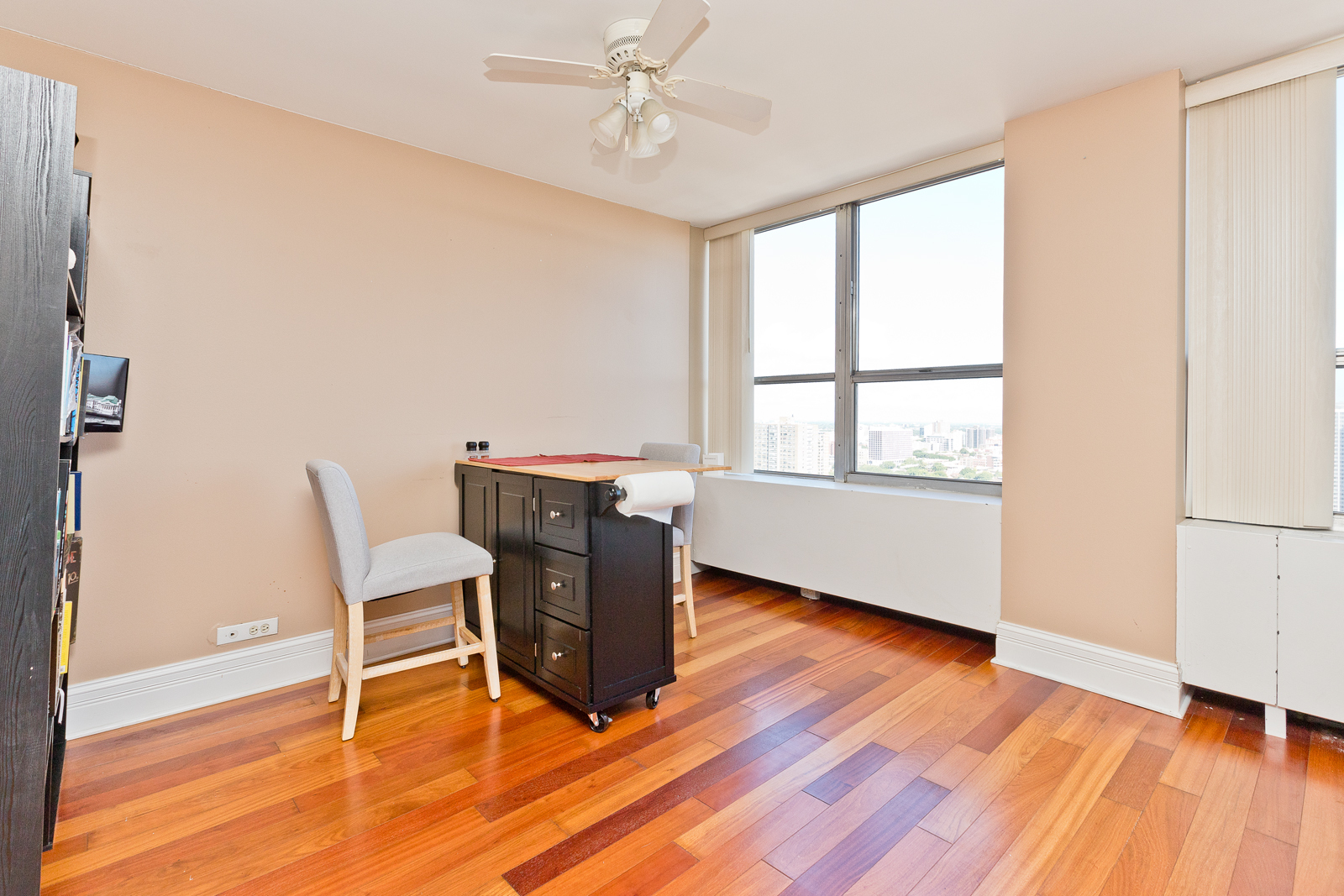 655 West Irving Park Road, Unit 2512 Chicago, IL 60613 - Photo 6 of 18 a view of a workspace with wooden floor and a window