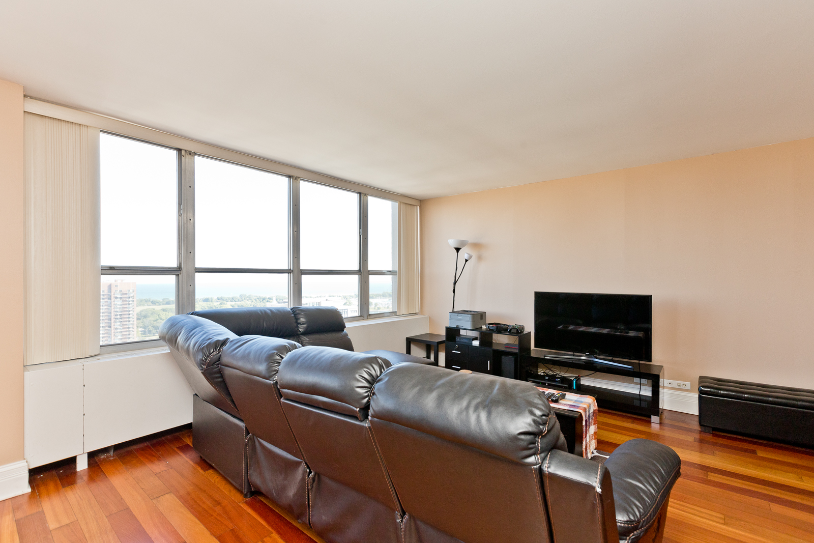 655 West Irving Park Road, Unit 2512 Chicago, IL 60613 - Photo 7 of 18 a living room with furniture and a flat screen tv