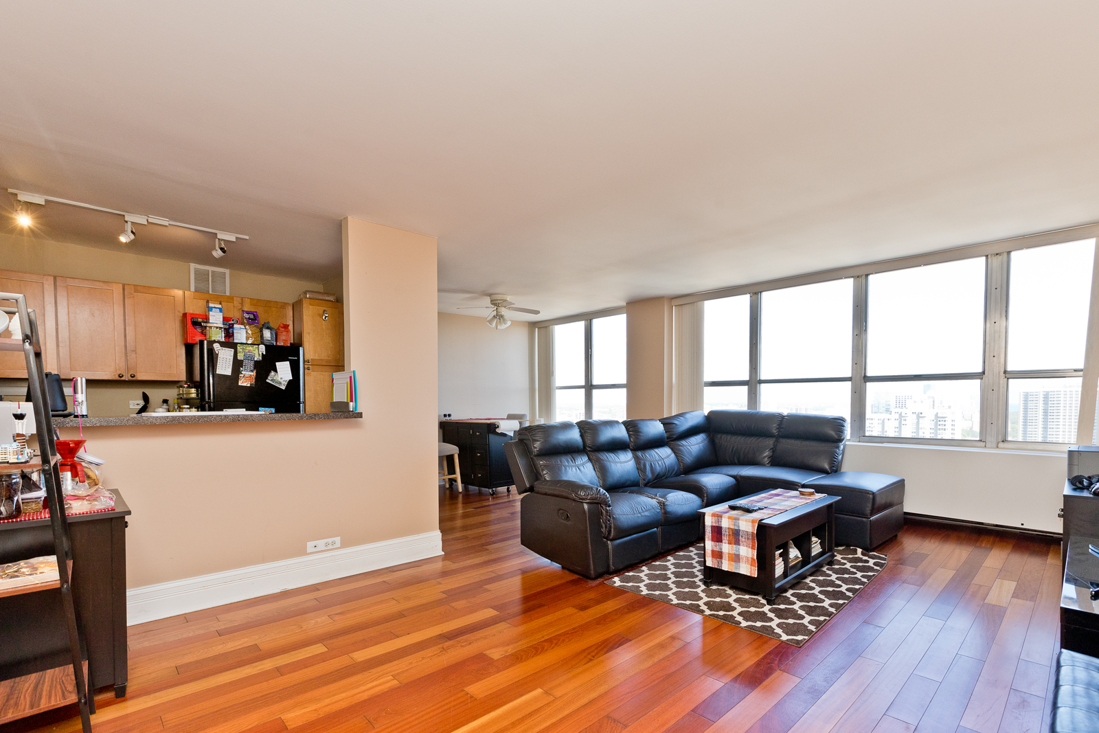655 West Irving Park Road, Unit 2512 Chicago, IL 60613 - Photo 8 of 18 a living room with furniture and a wooden floor
