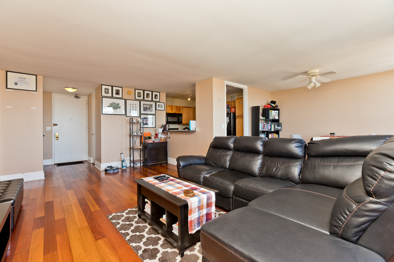 655 West Irving Park Road, Unit 2512 Chicago, IL 60613 - Photo 9 of 18 a living room with furniture and a wooden floor