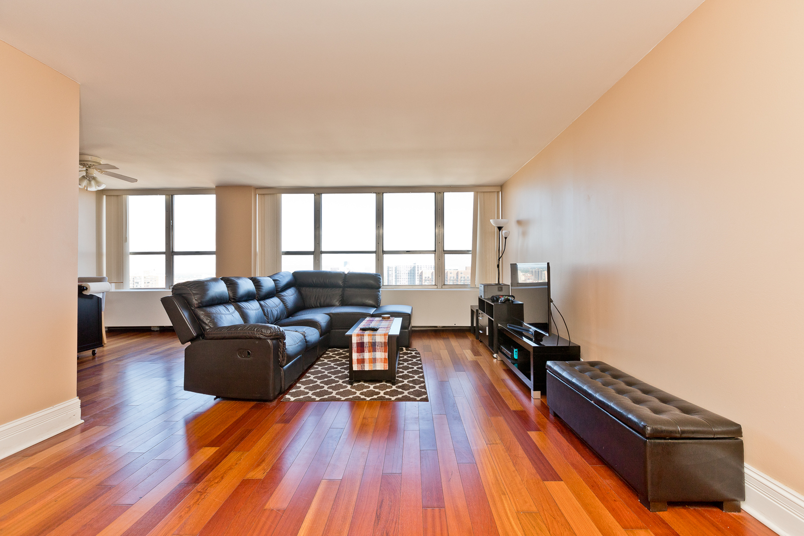 655 West Irving Park Road, Unit 2512 Chicago, IL 60613 - Photo 10 of 18 a living room with furniture and a wooden floor