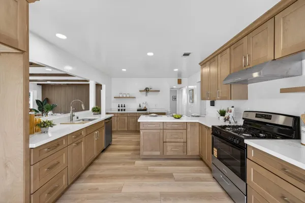 a kitchen with a sink stove and cabinets