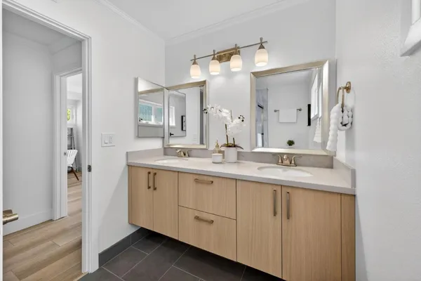 a bathroom with a double vanity sink mirror and
