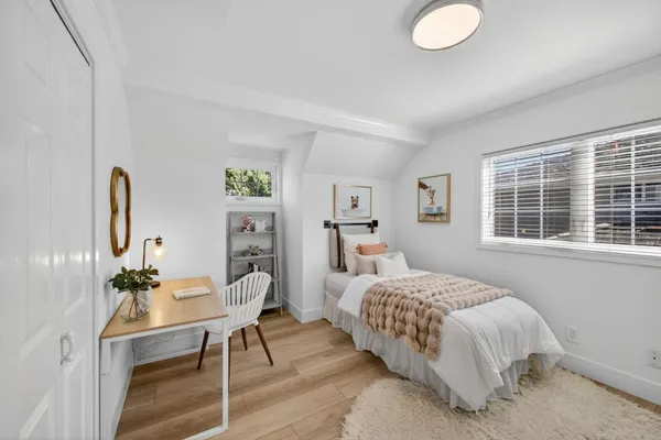 a bedroom with bed and a window