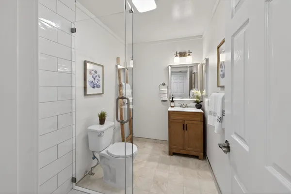 a bathroom with a sink a toilet and shower