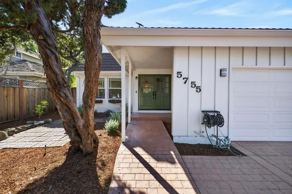 a front view of a house with outdoor seating