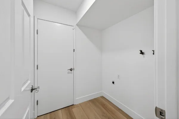 a view of a room with wooden floor