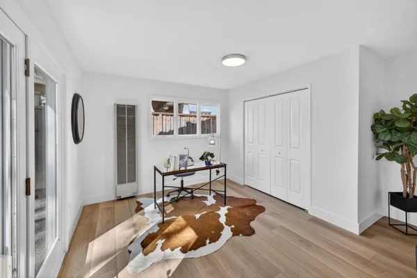 a living room with furniture and a wooden floor