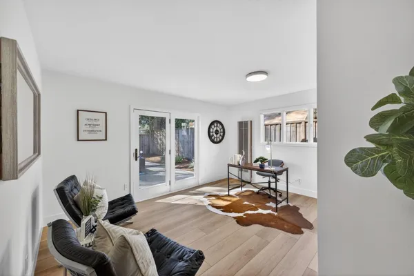 a living room with furniture and wooden floor