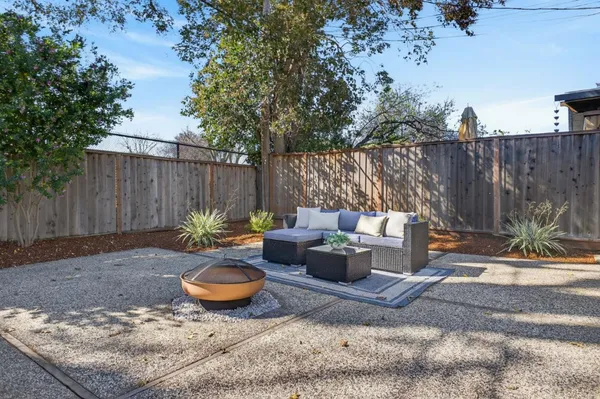 a backyard of a house with yard and outdoor seating