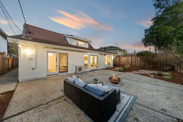 a view of a house with backyard and a patio