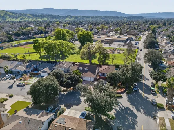 an aerial view of a house with a yard swimming pool and outdoor seating
