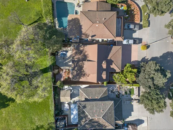an aerial view of a house with a yard basket ball court