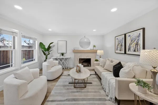 a living room with furniture a fireplace and a painting on the wall