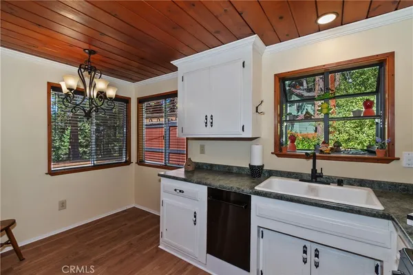 a kitchen with a sink window and cabinets