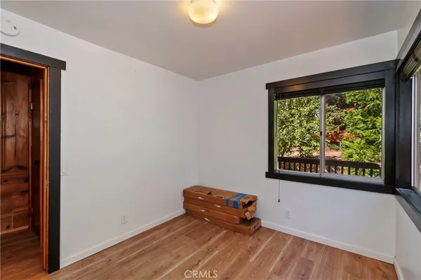 a room with a window and a ceiling fan