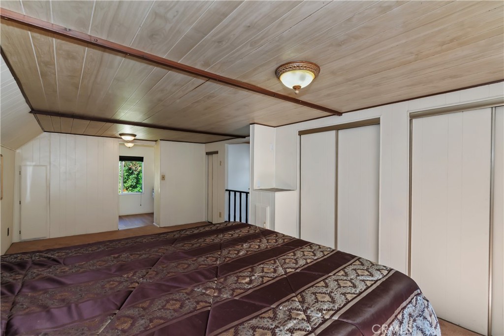 863 Oak Road Lake Arrowhead, CA 92385 - Photo 24 of 42 a bedroom with a bed and a window