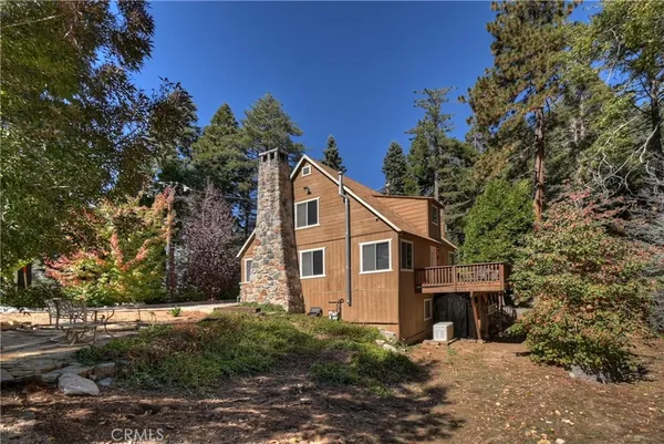 a house that has a tree in front of it