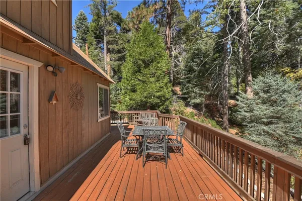 a balcony with wooden floor and city view