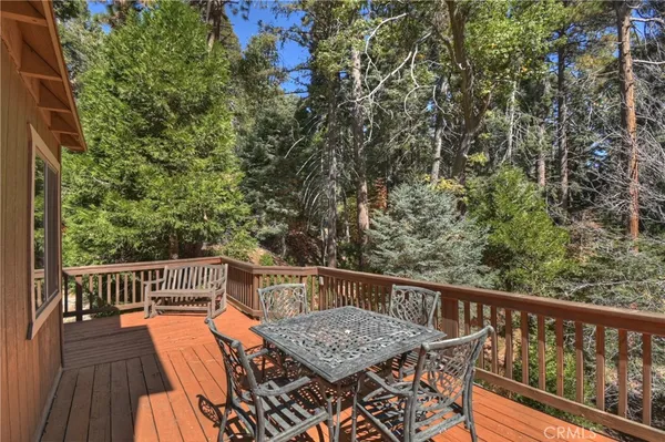 a view of balcony with wooden floor and seating space